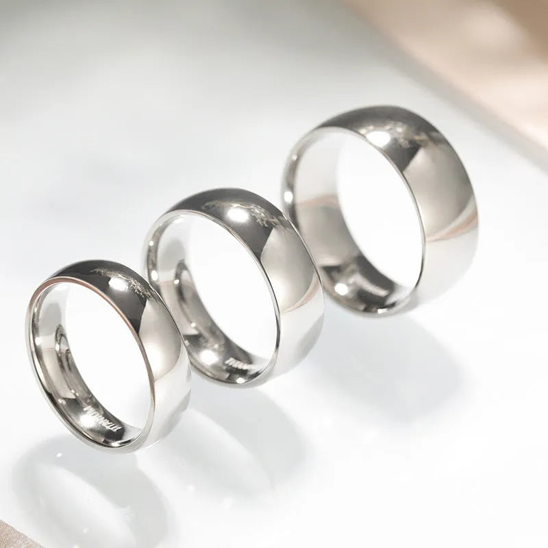 Solid titanium steel unisex ring in matte silver finish, shown in 2mm, 4mm, and 6mm band widths.