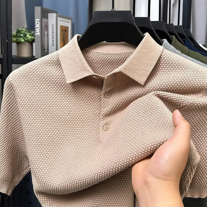 Man wearing a loose grey cotton short sleeve pullover sweater in a casual setting