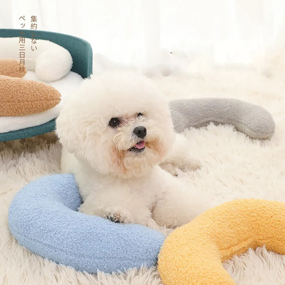 U-shaped blue cat pillow with an adjustable collar, shown on a cat bed.