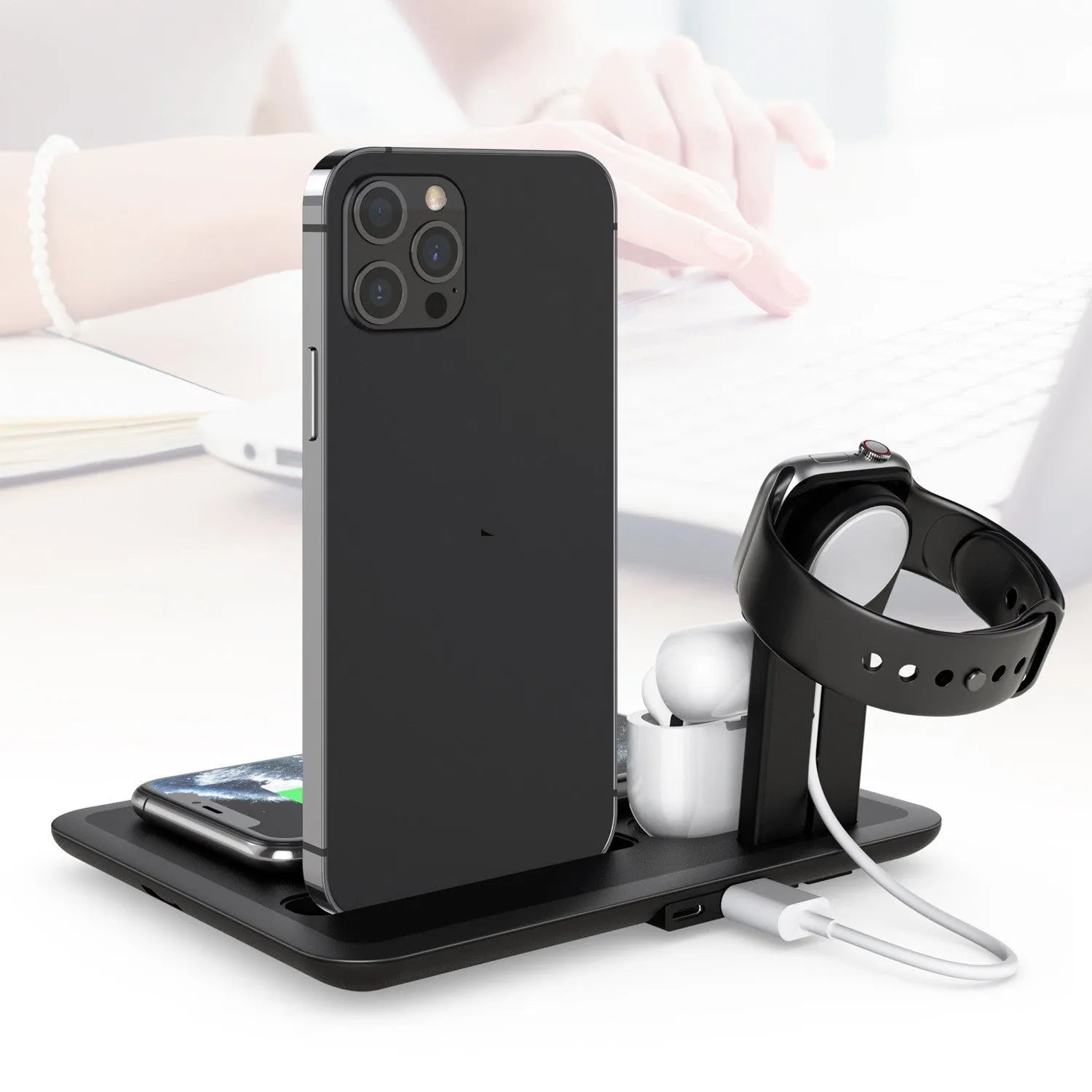 White desktop wireless charging station for phone, smartwatch and headphones showing compact design.