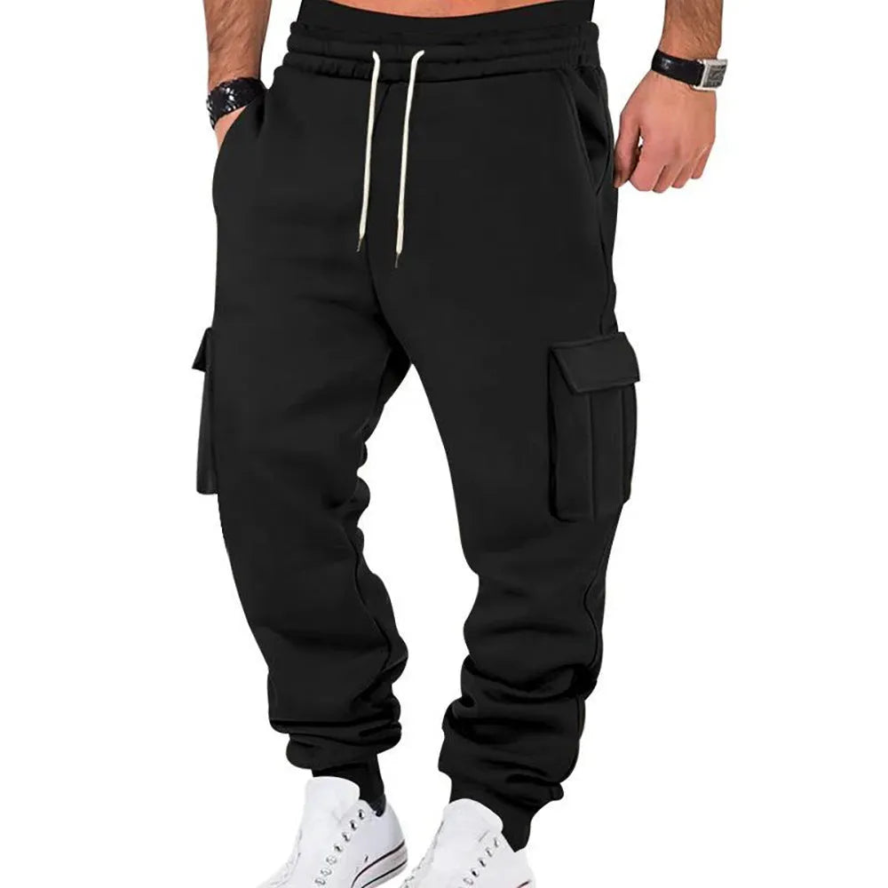 Men's solid colour casual multi-pocket drawstring sports pants in black, featuring polyester fabric and mid-waist design