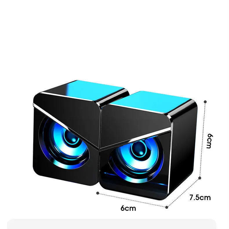 Black USB wired mini desktop speaker with volume knob next to white version, both measuring 7.5cm wide