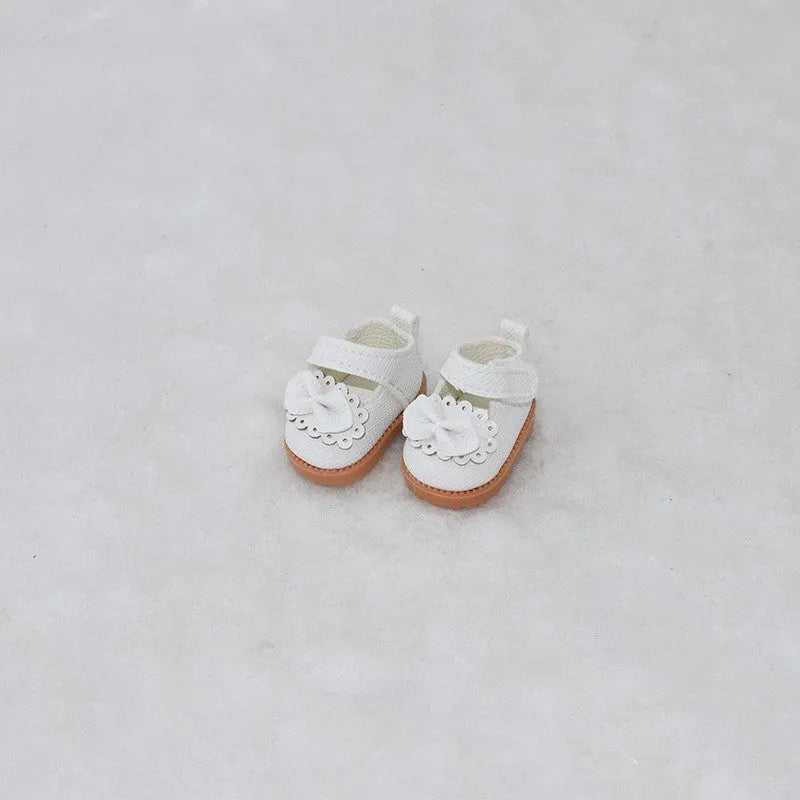 A pair of 17cm scale PU doll shoes in a selected colour and style, such as black leather shoes or brown boots.