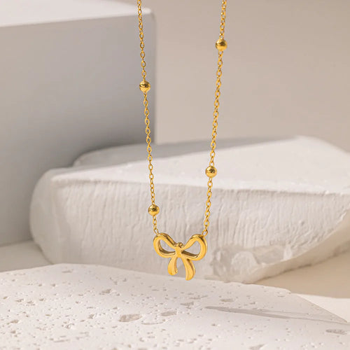 Gold bow necklace with adjustable chain on titanium steel with electroplated finish