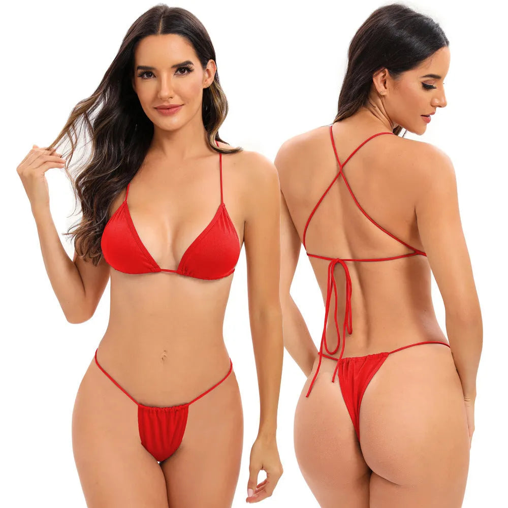 Women's striped one-piece swimsuit with cross-strap back, shown in a candy colour.