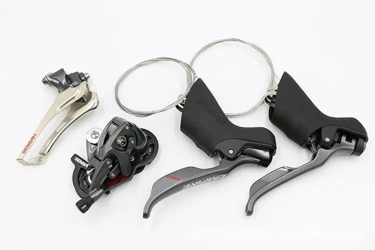 Aluminium road bike transmission kit showing hand change dial, front dial, short leg rear derailleur, chain, and decorative beads.