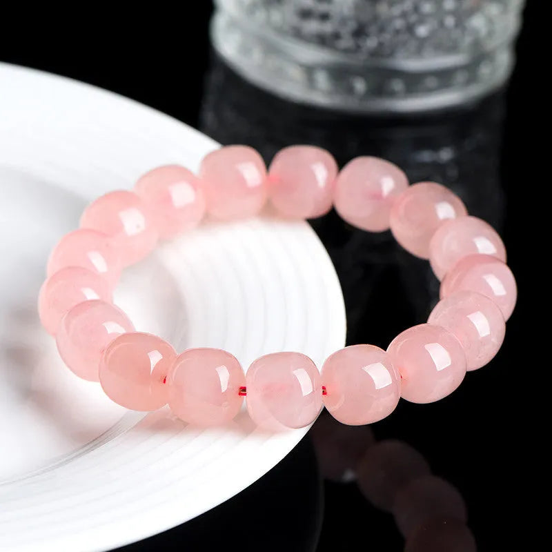 Natural pink crystal barrel bead bracelet with geometric design and polished finish