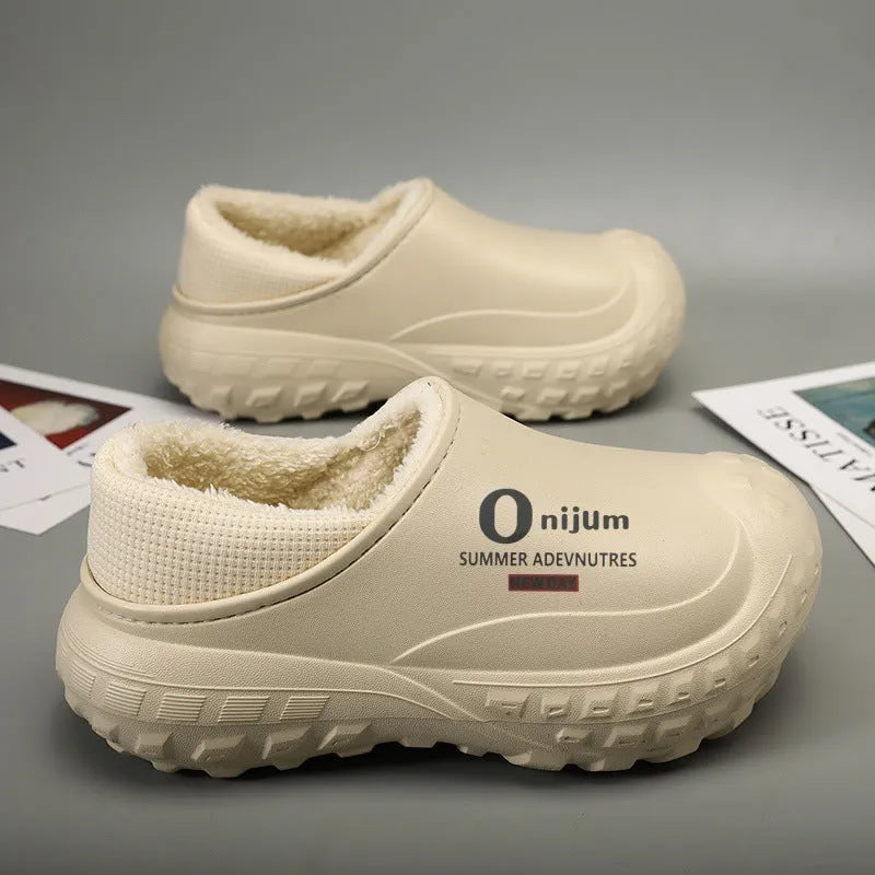 Winter fleece-lined men's home cotton shoes with anti-slip sole, printed letter pattern in black, on a floor
