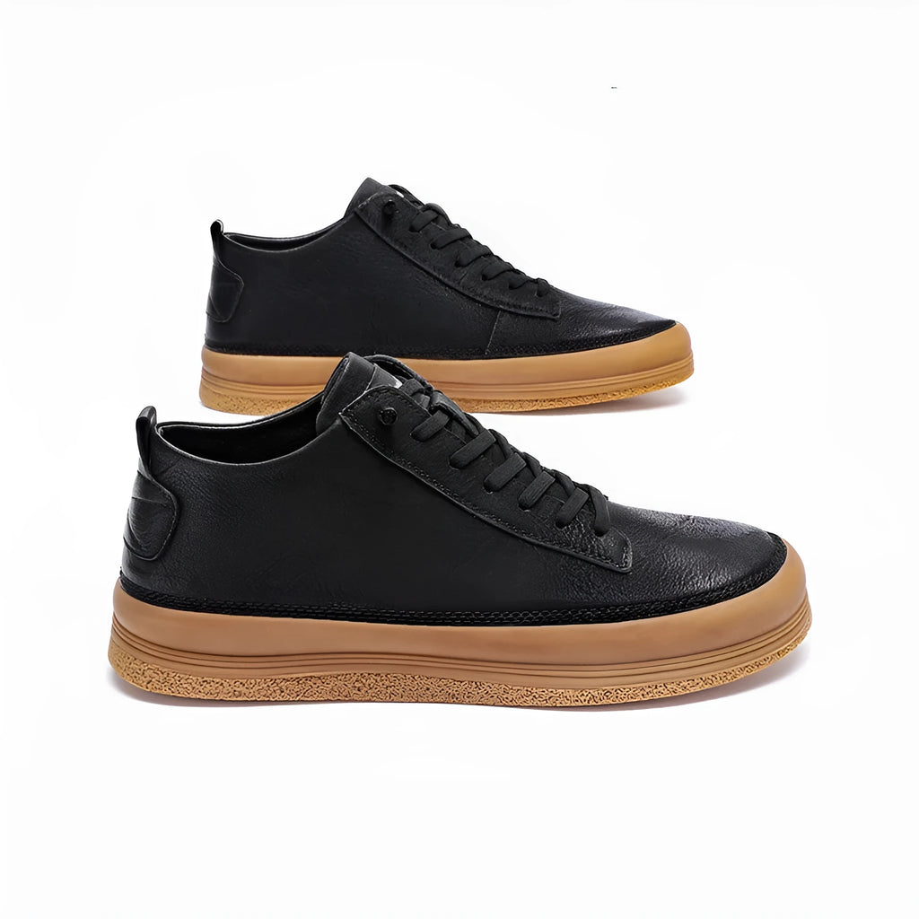 Men's black leather casual shoes with a round toe and white rubber sole on a plain background.
