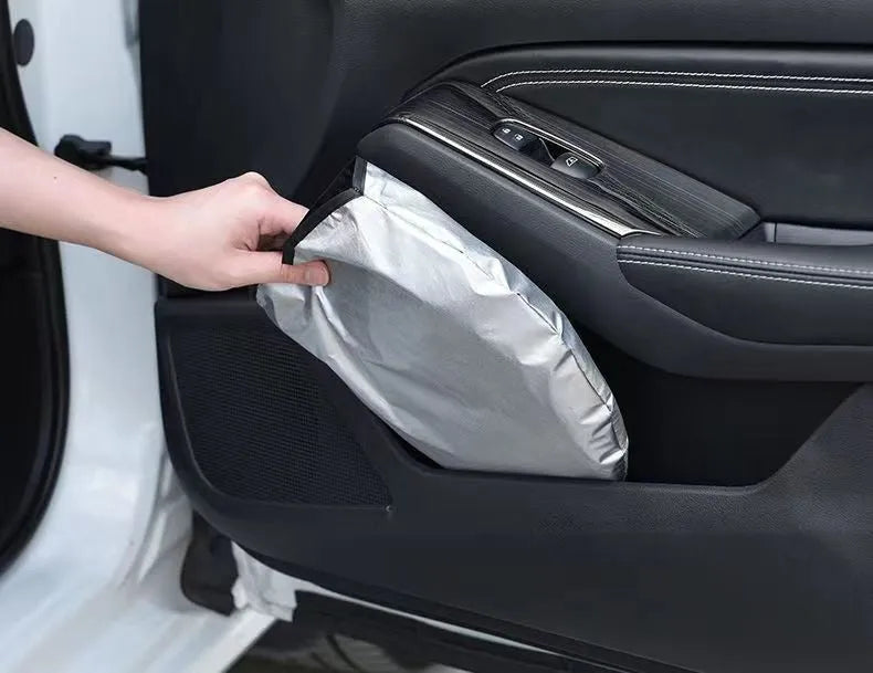 Titanium silver aluminium foil car windscreen sunshade unfolded on a dashboard.