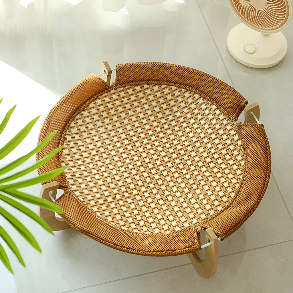 Brown woven rattan off-ground hammock bed for cats and small dogs.