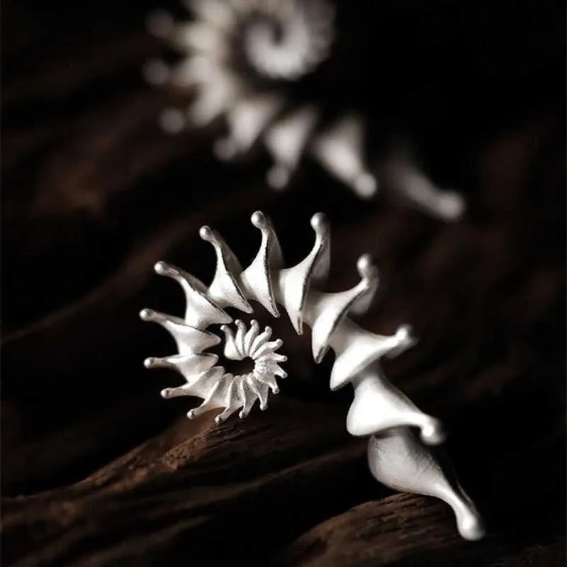 Three-dimensional matte finish conch shell stud earrings with exaggerated silhouette and simple styling