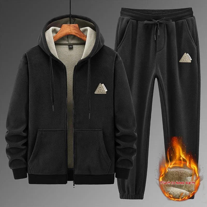 Grey cashmere hooded sportswear suit with long sleeves and matching trousers on a hanger