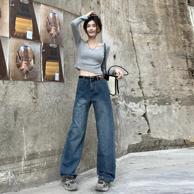 A pair of women's high waist straight leg jeans in retro blue cotton denim.