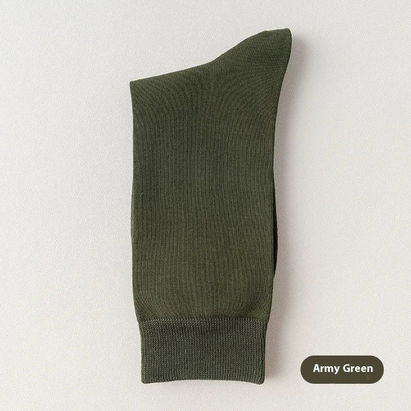 Five pairs of men's solid colour mid-calf socks made from combed cotton, shown in assorted shades.