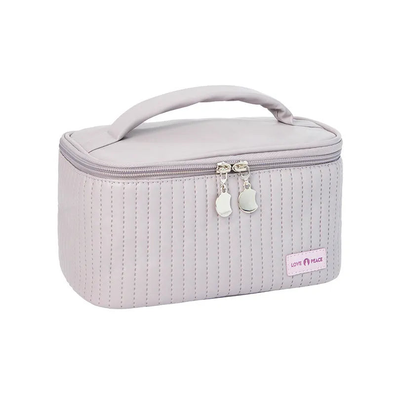 Open-top cake-shaped women's makeup bag in PU leather, shown in a soft solid colour.