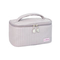 Open-top cake-shaped women's makeup bag in PU leather, shown in a soft solid colour.