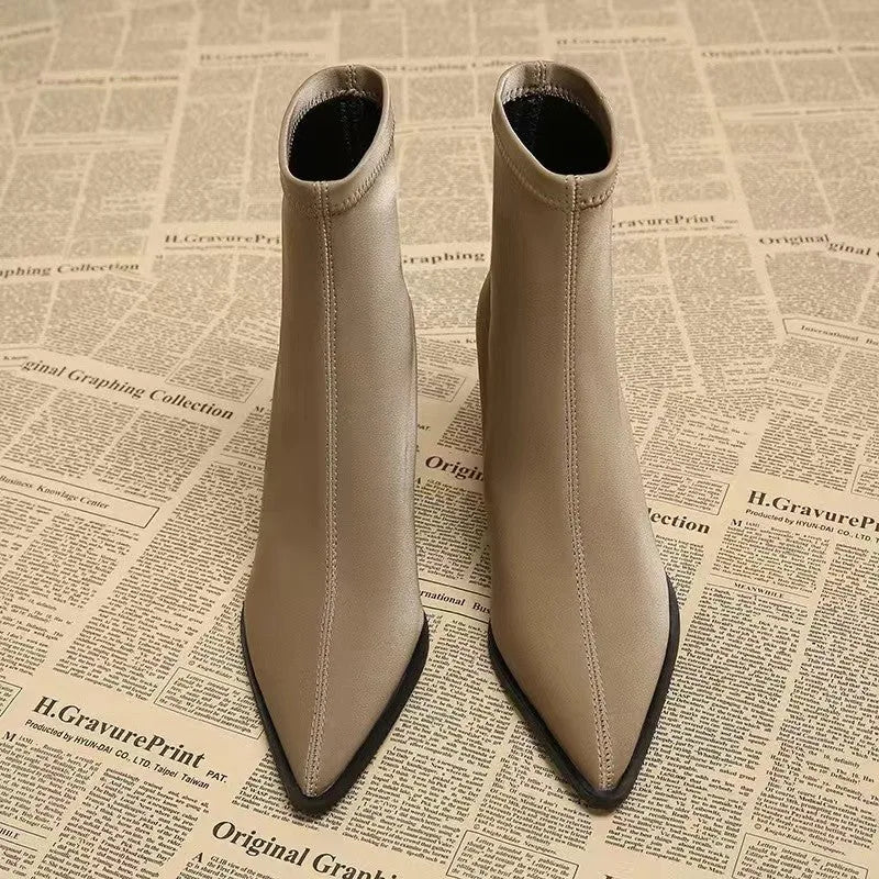 Women's khaki stretch suede pointed-toe ankle boots with a wedge heel on a white background.