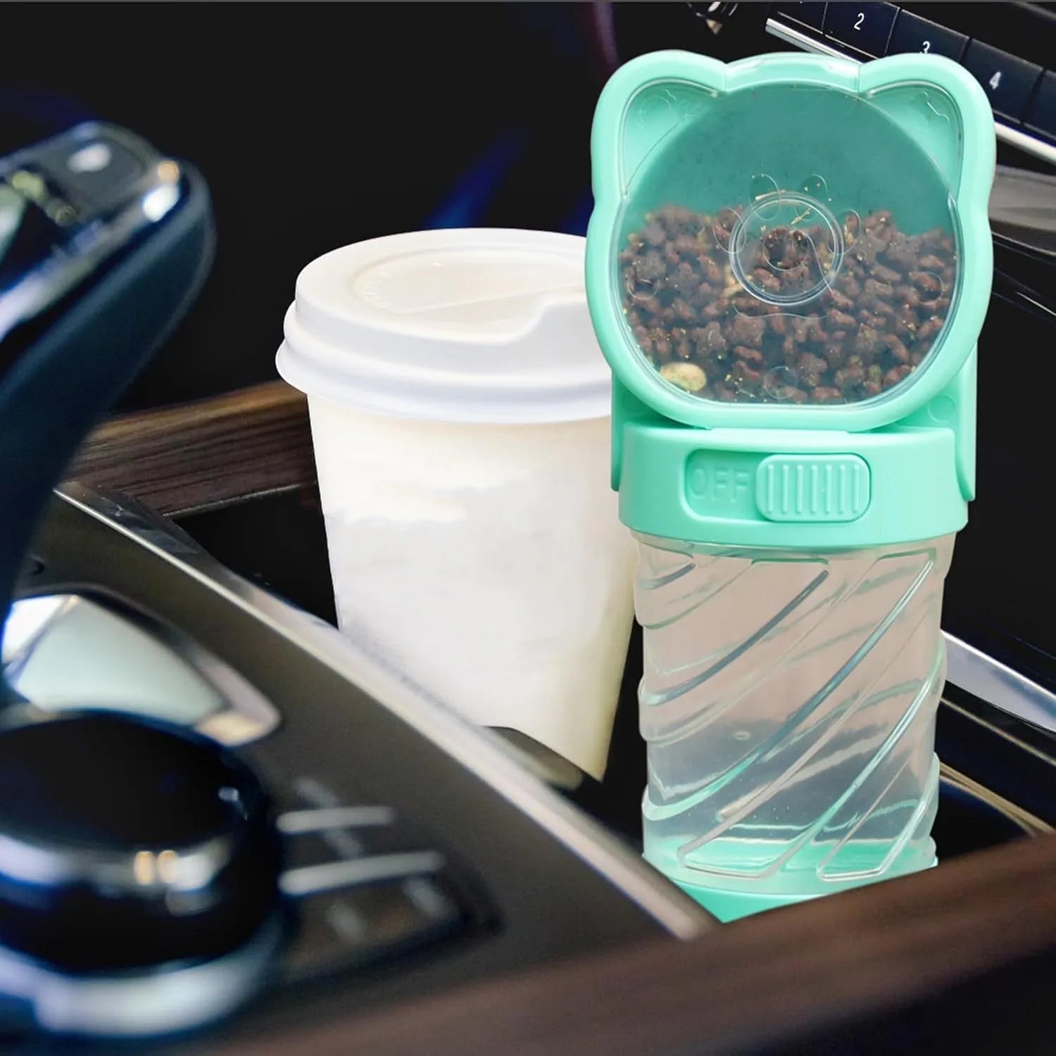 Green 3-in-1 pet water bottle with food container and waste bag dispenser, showing carrying strap.