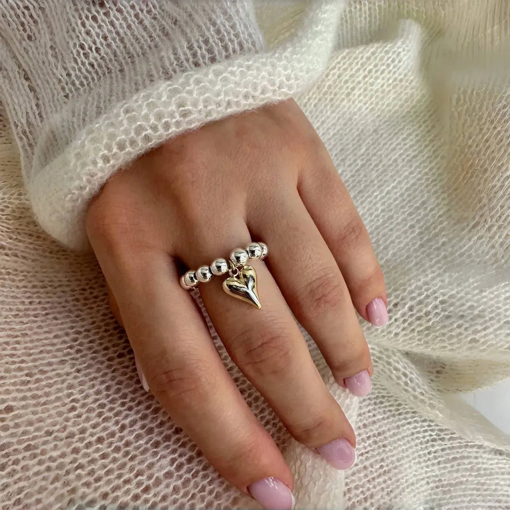 Handmade beaded elastic string love ring with geometric heart design in gold and white colour options