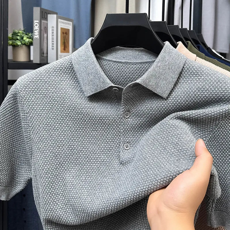 Man wearing a loose grey cotton short sleeve pullover sweater in a casual setting