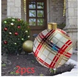 Large red and white striped inflatable Christmas ball ornament hanging on an outdoor tree