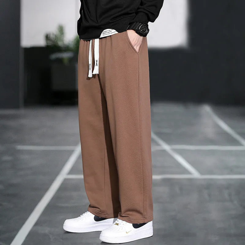 Casual grey men's sports trousers with multiple pockets and a high-waist design.