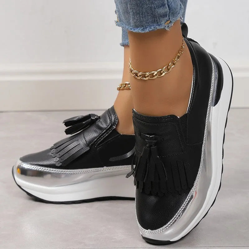 Women's black platform casual shoes with a tassel and a thick wedge heel.