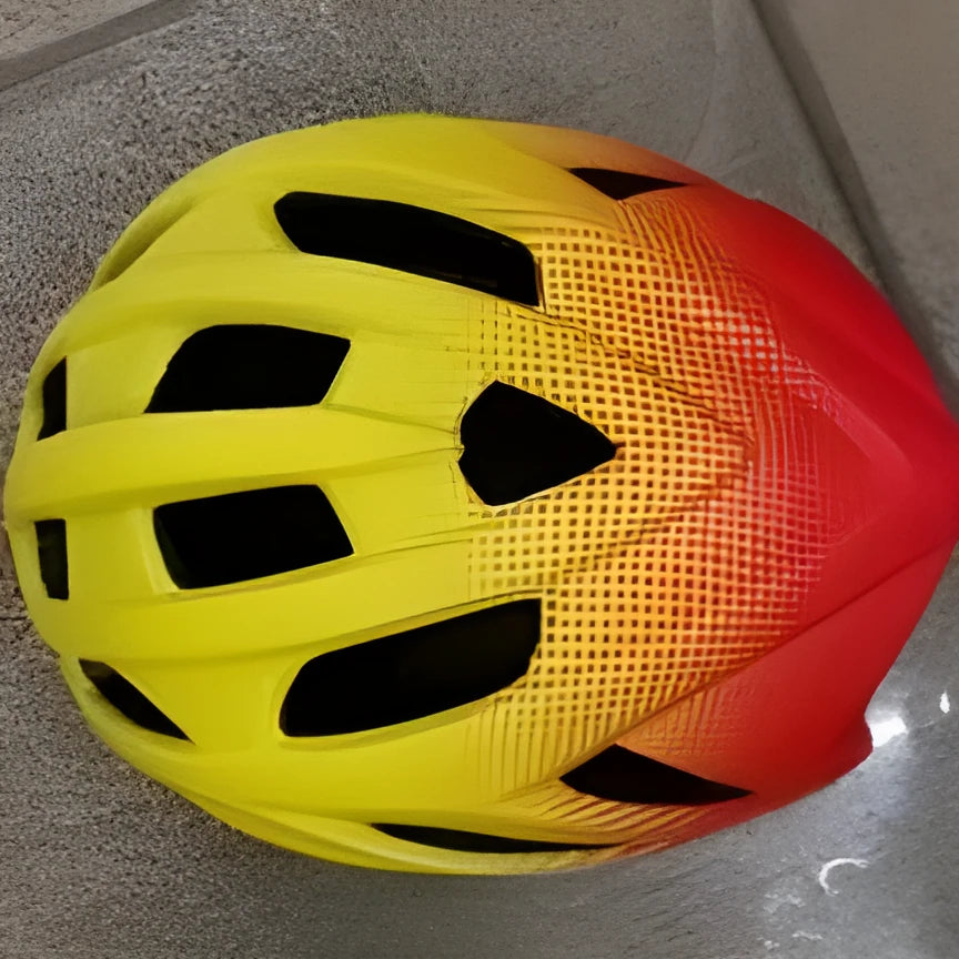 Orange mountain bike helmet showing ventilation holes and in-mould construction