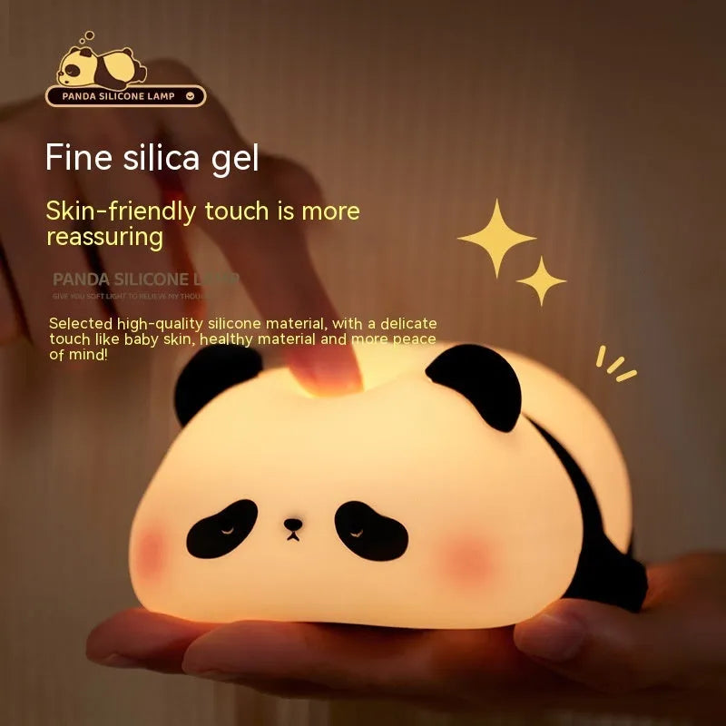 Cartoon panda rechargeable night light with soft silicone body on a wooden table