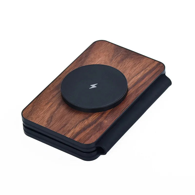 Three-in-one foldable magnetic wireless charger with walnut base and stand, charging a phone, earbuds and watch.