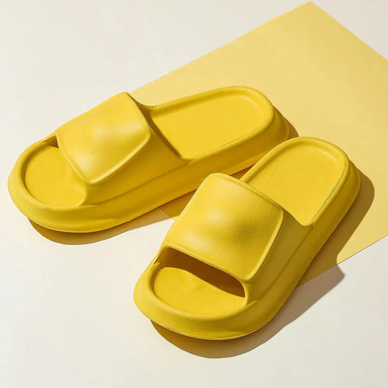 Pair of thick-soled EVA flip-flop slippers in a choice of seven colours, shown on a wet bathroom floor.