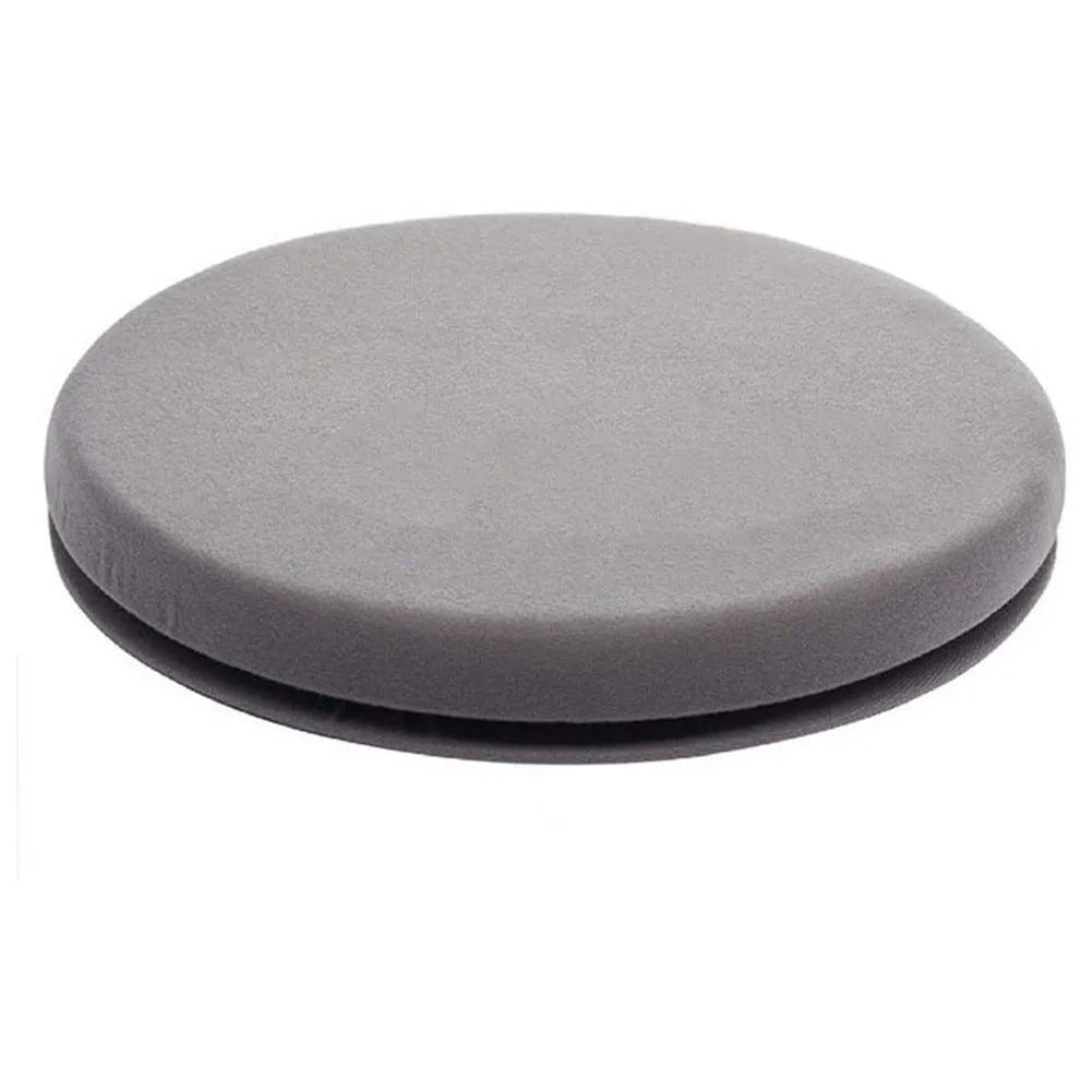 A grey rotating car seat cushion with a short plush cover, shown on a car seat.