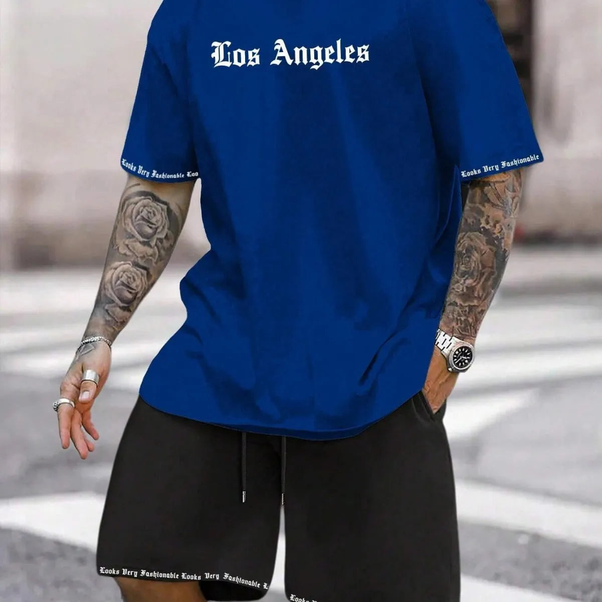 Men's blue short-sleeved sports top and matching shorts suit set on a hanger