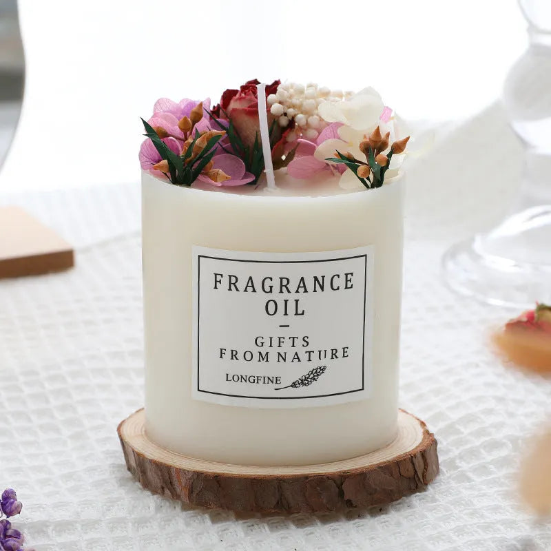 Aromatherapy candle with dried flowers on surface, shown in gift box with chip base.