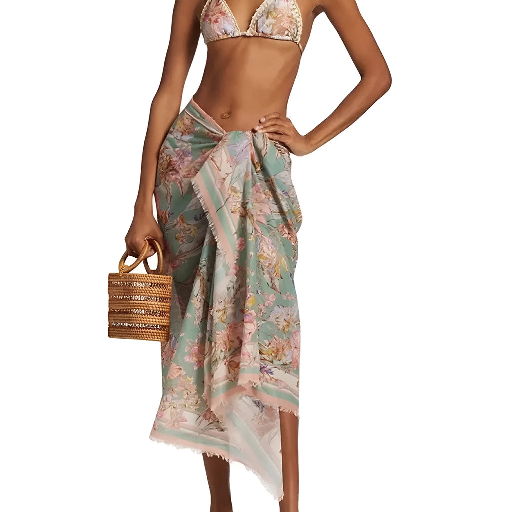 Women's creamy white floral bikini set with halter top, high-waisted briefs and matching skirt