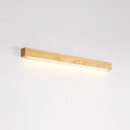 Long, slim walnut-coloured wooden wall lamp with integrated LED light, shown in a minimalist room setting.