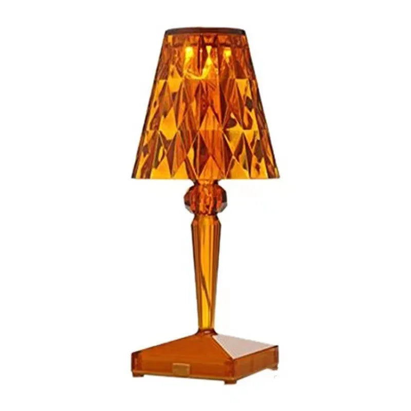 Rose gold plated portable touch night light with rechargeable battery on a table.