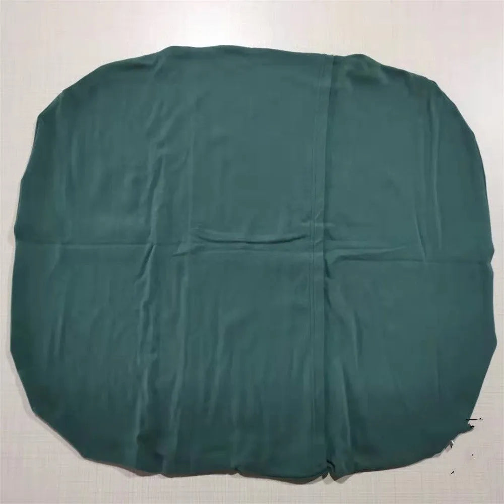 Cotton portable baby nest crib for newborns, beige colour, shown on a bed.