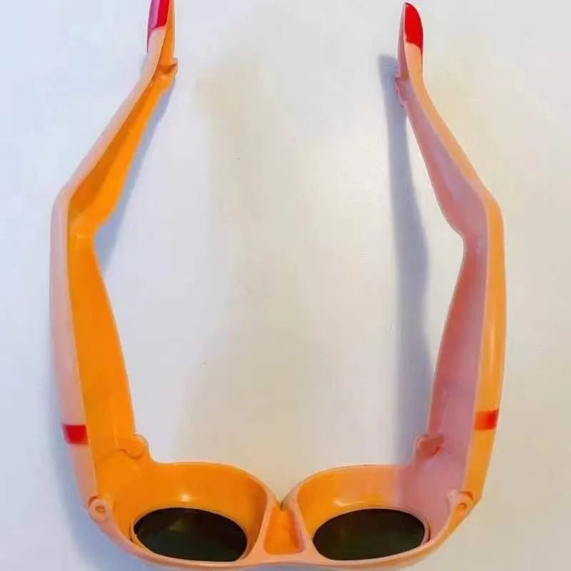 Orange plastic novelty sunglasses with leg hip style arms and a large wide frame.