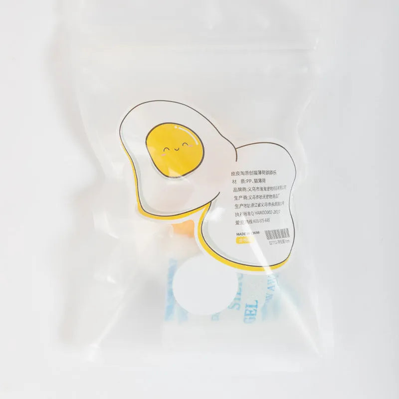 Soft plush catnip ball toy in fried egg and poached egg shapes for wall-mounted cat play