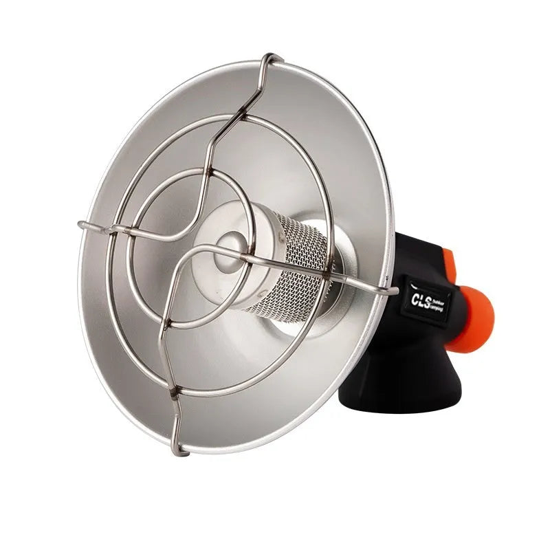 Black and orange portable outdoor heating stove with automatic ignition on a camping table.