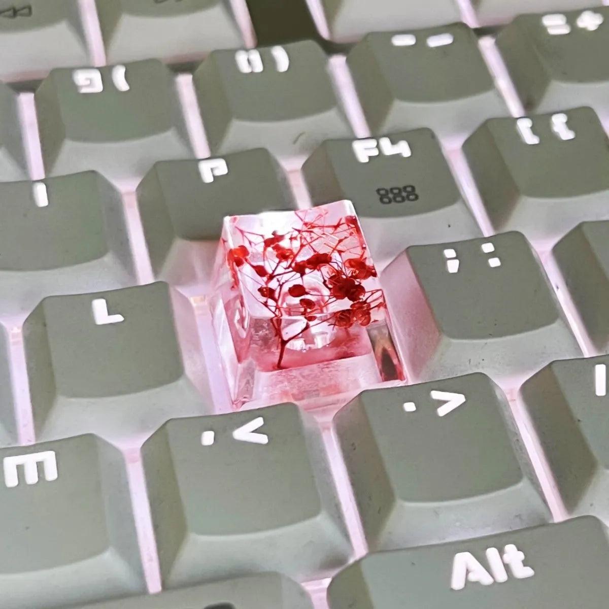 Transparent resin mechanical keyboard keycap with starry sky pattern in red, pink, green, and violet colour options