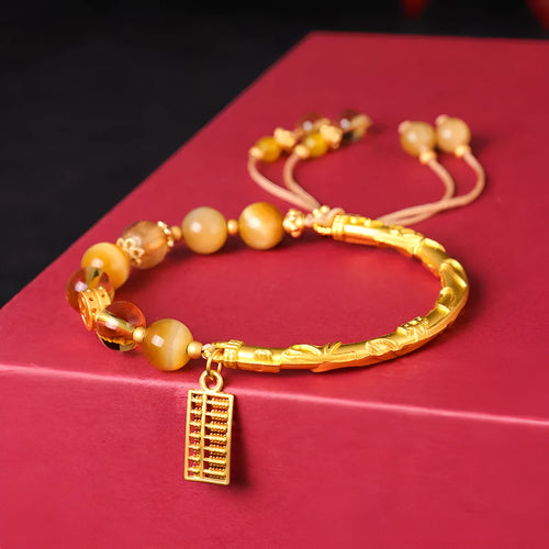 Women's beaded bracelet with tigereye, citrine, and yellow tower crystal beads in a diamond pattern.