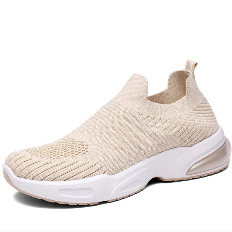 A pair of low-top slip-on sock shoes with a mesh upper and PVC sole on a plain background.