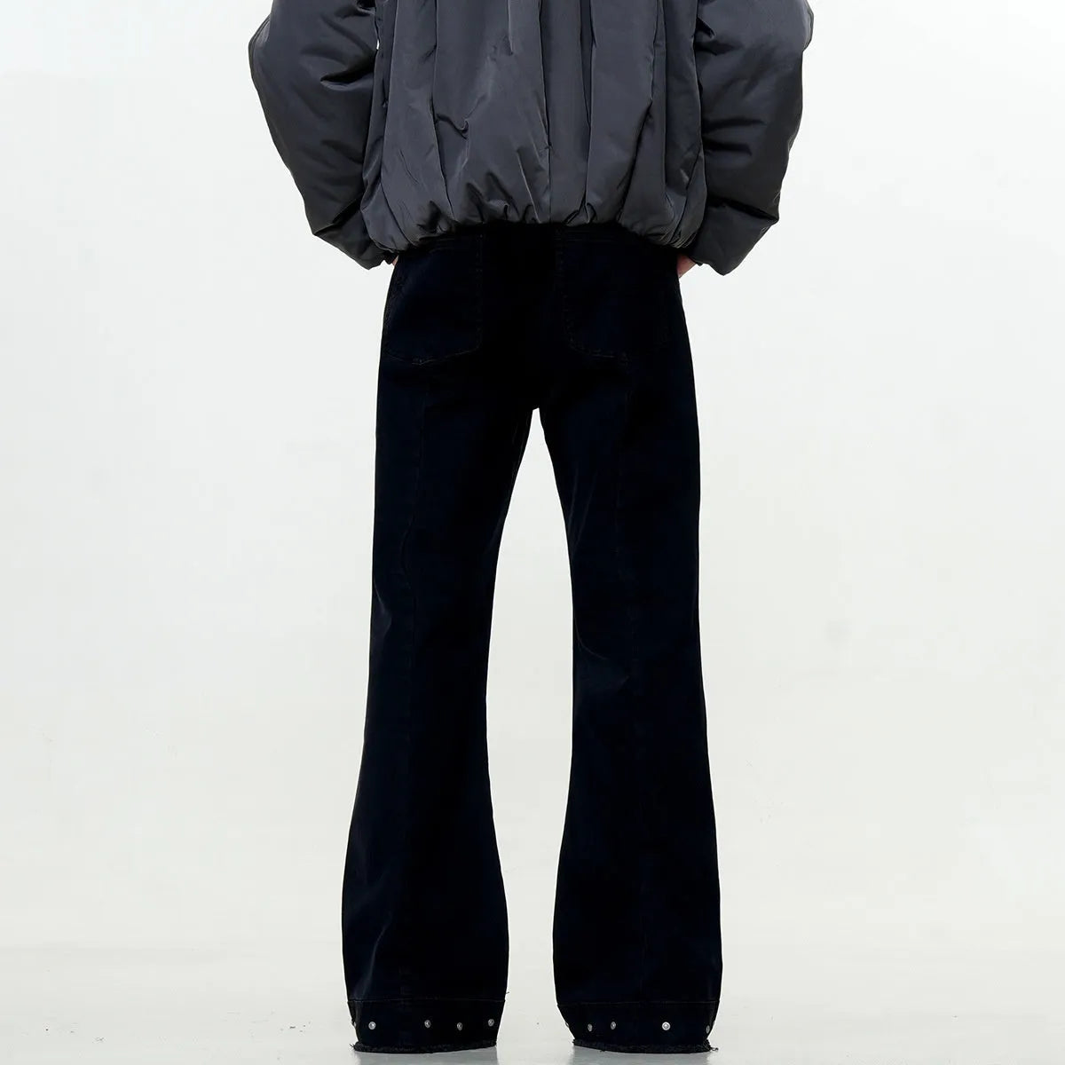 Black American retro straight-leg skinny jeans on a hanger, showing mid-waist and zipper fly detail.