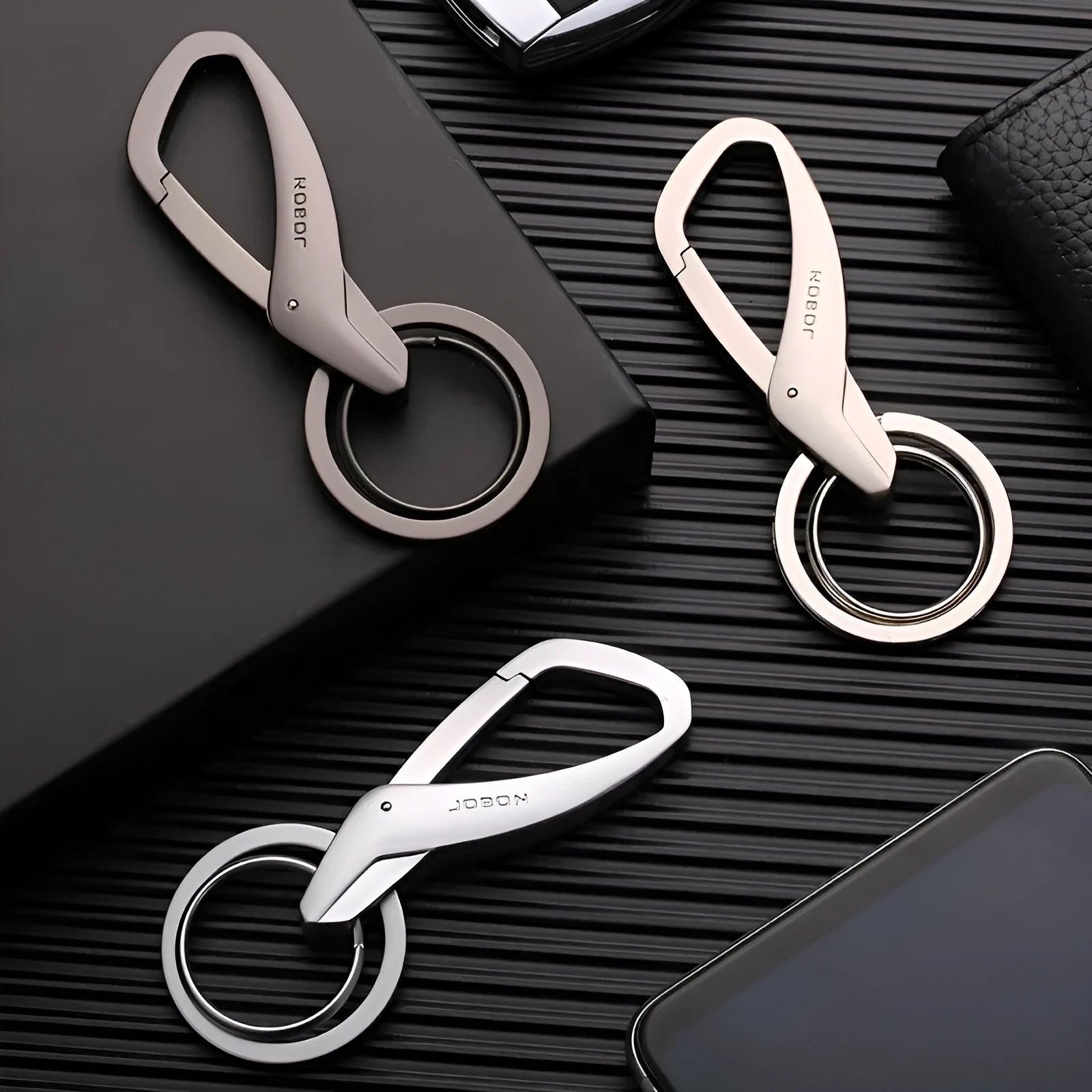 Black zinc alloy double ring car keychain attached to a belt loop.