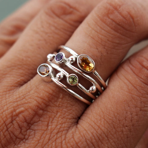 Silver bohemian diamond studded hollow copper ring with geometric ellipse shape on plain background