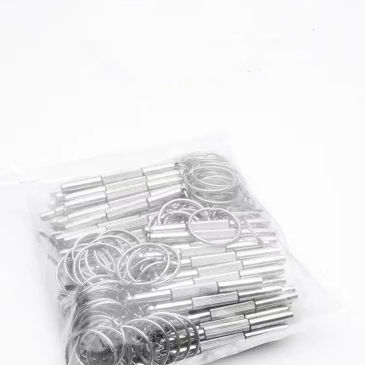 Stainless steel three-purpose screwdriver tool for glasses repair on a clean surface
