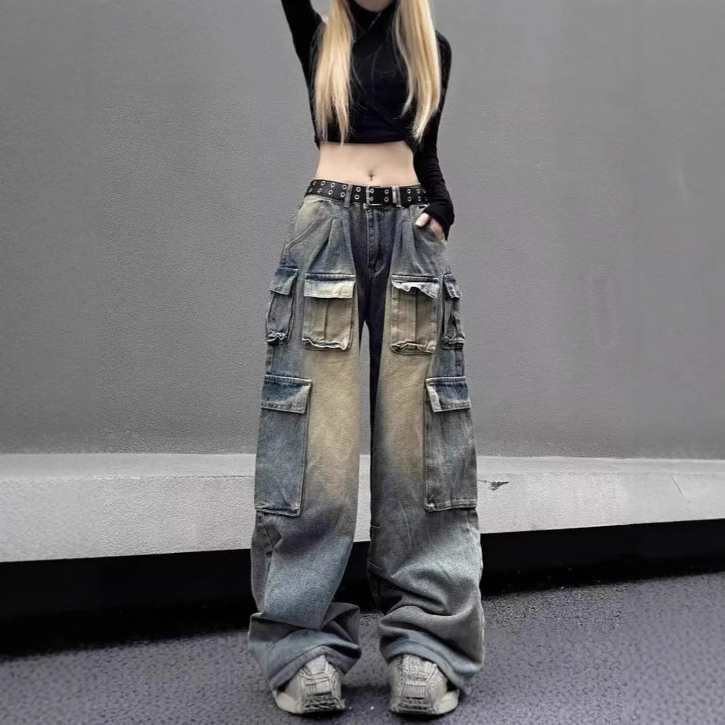 Loose-fit distressed denim pants with multiple pockets in light blue wash, straight-leg street style